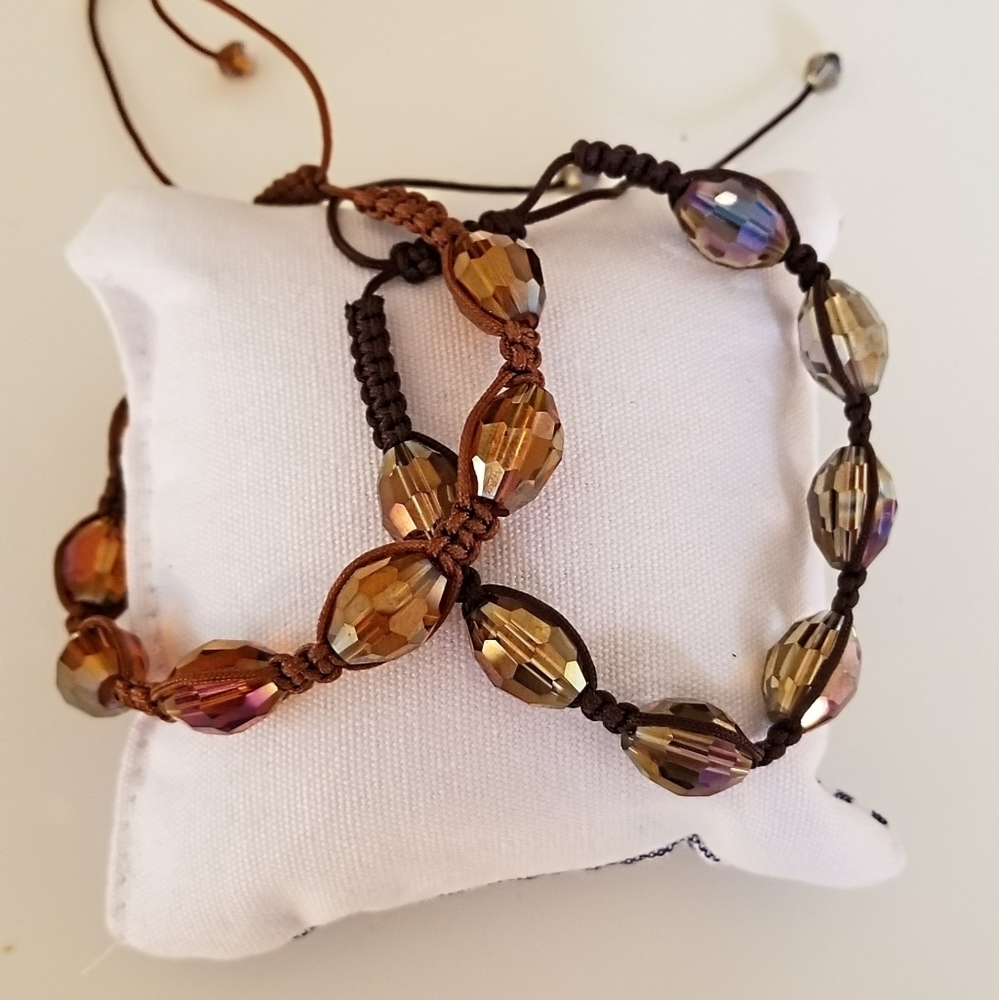 Two fashion bracelets with iridescent finish and faceted crystals.